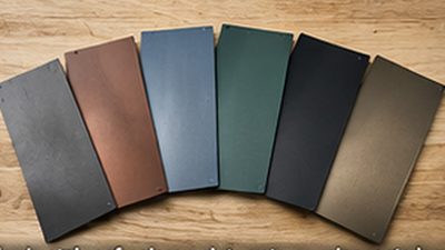 Metal roofing color samples in charcoal, copper, slate gray and forest green